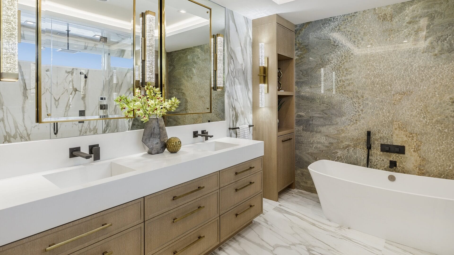 A laundry room with a chandelier and a washer and dryer